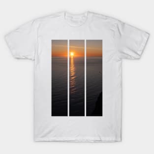 Wonderful landscapes in Norway. Nord-Norge. Beautiful scenery of a midnight sun sunset at Nordkapp (Cape North). Boat and globe on a cliff. Rippled sea and clear orange sky. (vertical) T-Shirt